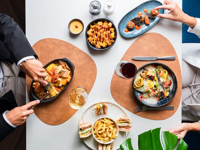 Two persons enjoying a meal at Moments
